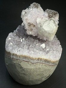 lot 10 image: A stunning Amethyst crystal perched on its natural matrix, featuring delicate Calcite inclusions that add depth and character. 1lb 15.6 oz.  0.896 kg.