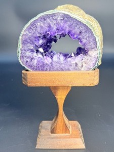 A mesmerizing deep amethyst portal, showcasing rich violet crystals that form a natural, glowing window into the stone’s heart. On a custom wooden stand. 1 lb 2.3 oz. / 0.519 kg.