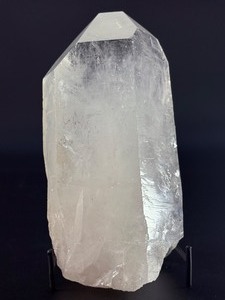 lot 29 image: A Brazilian Clear Quartz Point is a powerful and timeless crystal. This naturally formed point features a polished or semi-polished body with a sharp, fully terminated tip, allowing energy to flow smoothly and with intention. 3 lbs 5.8 oz.  1.527 kg.