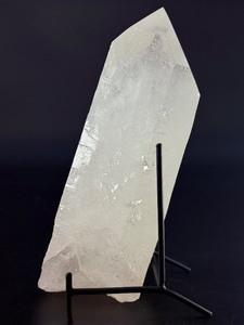 lot 29 image: A Brazilian Clear Quartz Point is a powerful and timeless crystal. This naturally formed point features a polished or semi-polished body with a sharp, fully terminated tip, allowing energy to flow smoothly and with intention. 3 lbs 5.8 oz.  1.527 kg.
