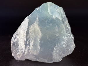 lot 34 image: A Blue Raw Fluorite piece showcases the crystal in its natural, unpolished state, highlighting its geometric formations and soft to vibrant blue hues. 15,7 oz.  0.447 kg.