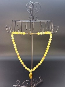 lot 38 image: This is a beautifully crafted piece that blends the warm, golden tones of honey calcite with symbolic spiritual energy. The Gyan Mudra hand charm representing wisdom and spiritual connection.