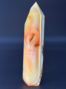 lot 42 image: Carnelian Flower Agate Tower is a stunning hand-carved crystal that combines the vibrant, energizing hues of carnelian with the earthy, patterned beauty of flower agate. 1 lb 2.0 oz.  0.511 kg.