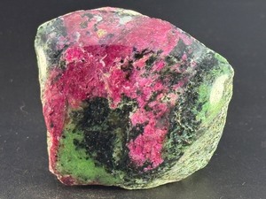lot 48 image: Ruby Zoisite is a striking natural stone that beautifully blends vibrant ruby inclusions with earthy green zoisite, often accented by dark hornblende veins.12.0 oz.  0.343kg.