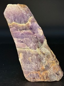 lot 50 image: Raw Chevron Amethyst showcases the stone in its natural, unpolished form, highlighting bold V-shaped bands of deep purple amethyst and milky white quartz.&nbsp2 lbs 7.3 oz.  1.115 kg.
