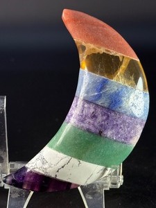 lot 60 image: Moon-Shaped Crystal with Red Jasper, Tiger Eye, Sodalite, Charoite, Aventurine, Howlite &amp Amethyst is a vibrant, multi-stone piece carved into a graceful crescent moon. 5.2 oz.  0.149 kg.