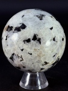 lot 63 image: Rainbow Moonstone Sphere is a luminous and enchanting crystal sphere known for its soft glow and mesmerizing flashes of blue, rainbow, and pearly light that shimmer as it moves.&nbsp1 lb 0.9 oz.  0.481 kg.