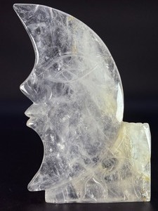 lot 69 image: Hand-Carved Moon with Rose is a beautifully detailed crystal carving that blends celestial symbolism with gentle, heart-centered beauty. Shaped into a graceful crescent moon and adorned with a delicately carved rose, 2 lbs 10.2 oz.  1.197 kg.