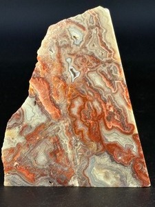 lot 77 image: Crazy Lace Agate is a vibrant and eye-catching crystal known for its intricate, swirling patterns and lively mix of colors, typically including creamy whites, warm reds, oranges, and browns.&nbsp