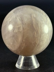 lot 80 image: Blue Quartz Sphere is a polished crystal sphere that showcases the calming, ethereal beauty of blue quartz. 15.3 oz.  0.436 kg.