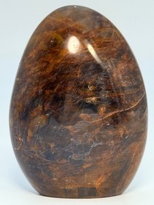 lot 85 image: Brown Quartzite Freeform is a naturally shaped, polished stone that highlights the earthy, warm tones and subtle striations of quartzite. 1 lb 9.8 oz.  0.733 kg.