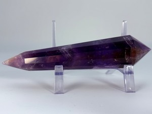 lot 86 image: Extra Large Amethyst Vogel Double Terminated is a powerful and visually striking crystal, expertly carved into the iconic Vogel shape with pointed terminations at both ends.12.3 oz.  0.350 kg.