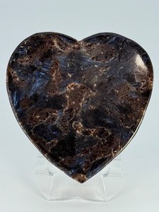 lot 87 image: Arfvedsonite Heart Dish is a beautifully hand-carved crystal dish shaped like a heart, showcasing the deep, inky blue-black tones and striking natural patterns of arfvedsonite. 6.7 oz.  0.190 kg.
