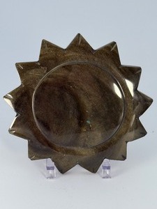 lot 91 image: Golden Obsidian Sun is a striking crystal piece carved into a radiant sun shape, showcasing the deep black sheen of obsidian accented with shimmering golden flashes.&nbsp9.1 oz.  0.259 kg.