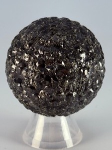 lot 94 image: Chiseled Obsidian Sphere is sculpted from a&nbsp&nbspsmooth polished surface. Subtle chiseled facets, creating depth, texture, and a dynamic play of light across the stone.&nbsp5.8 oz.  0.167 kg.