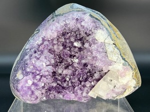 lot 2 image: A natural amethyst geode filled with shimmering violet quartz crystals, accented by soft white calcite and encased in its original stone shell. 4 lbs 8.8oz.  2.065 kg.