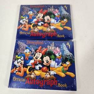 lot 64 image: Lot Of Two New Disney Land Autograph Books Blue