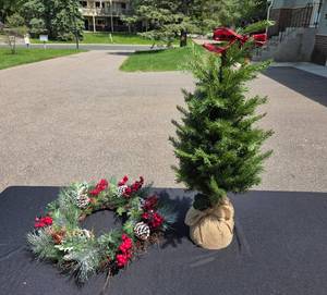 lot 315 image: Artificial Pine Tree with Burlap Base and Decorative Holiday Wreath