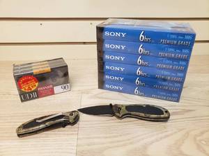 lot 9 image: Sony T-120 6 Pack VHS tapes, 3 pack of Maxell High Resonance proof Cassette Mechanism, and 2 Camo Folding Pocket Knives