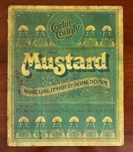 lot 310 image: Mustard Advertisement Counter Mat  Wall Sign