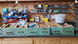 lot 47 image: Vintage Green Drawers Filled with Misc Hardware and Trays on Wall Filled with Screws, bolts ect.