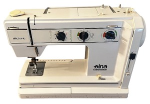 lot 3 image: Antique ELNA CARINA Sewing Machine with Sewing Machine Accessories