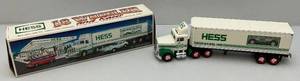 lot 34 image: Vintage Collectible HESS Gasolene Semi TruckCar hauler With Race Car (NIB)