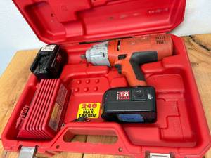lot 42-F2025 image: Heavy duty Milwaukee, 18 V impact wrench cannot log number 907921, 1 working 18 V 2.4 amp battery holds charge, 1 18V battery for rebuild, one Milwaukee power plus universal charger