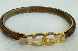 lot 69R image: Vintage Leather Gucci Bangle with Gold-Plated GG Logo