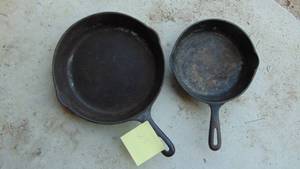 lot 23 image: 2- Cast Iron Pans, Small One is Taiwan and Large one is a #8 USA