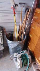 lot 43 image: Hose Reel, Trash Can with Pole Saw and Misc Garden Tools