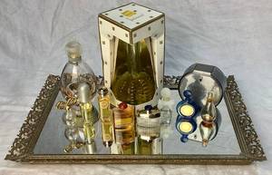 lot 33 image: Vintage Gold Vanity Mirror with 11 Vintage Perfume Bottles