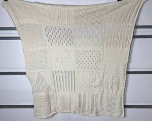 lot 60 image: Handcrafted Off White Knit Multi Stitch 70 x 66 Throw