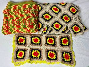 lot 75 image: Retro Crocheted Blanket Bundle - One 48 X 48 Blanket Throw in Red, Green and Yellow, One Accent Throw 35 x 58 and One 23 x 23 Seat Cover