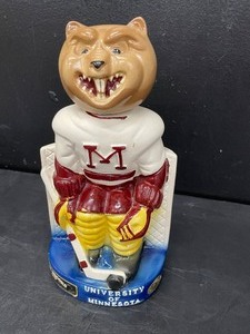 lot 120 image: Vintage, 1975 U of MN Gophers hockey goalie decanter, Ezra Brooks