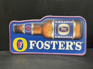 lot 128 image: Fosters Lager tin tacker, NOS