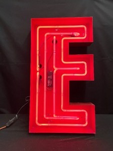 Ruby Red neon "E" with red metal outline, red channel letter, neon sign letter