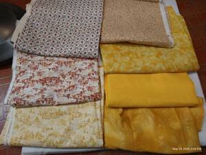 lot 111 image: Seven Warm-Toned Cotton Fabrics, 2 Yards Each