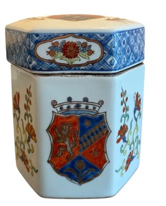 lot 25D image: Vintage Hexagonal Porcelain Lidded Jar with Floral and Crest Motif, 6.25 Inches Tall