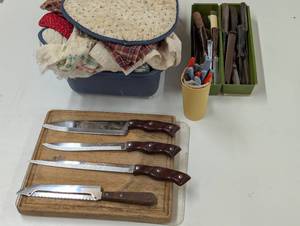 lot 212 image: Camping Cooking Supplies - Cutting Board - Variety Knifes - Pot Holders and Table Clothes
