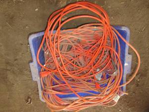 lot 128 image: Blue bin filled with extension cord...