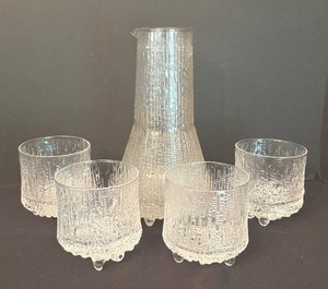 lot 125 image: Iittala Ultima Thule Carafe with Four Coordinating Low Ball Glasses  Iittala Ultima Thule Cocktail Pitcher Set