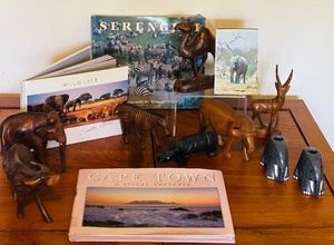 lot 117 image: African Souvenir Treasures including Hand Carved Animals, Informational Books, Candle Holders and More