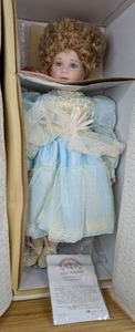 lot 49 image: New Cora Porcelain Doll World Gallery Collection by Thelma Resch 1082000 with Certificate of Authentication