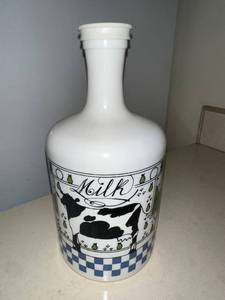 lot 131 image: Vintage Milk Bottle with Cow and Pear Design