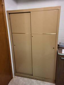 lot 301 image: Tan Vintage Metal Storage Cabinet with Sliding Doors