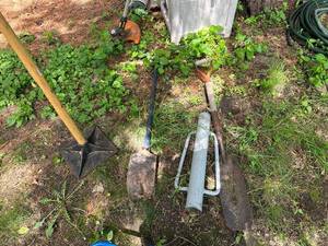 lot 45 image: Group of Manual Garden Tools Including Post Hole Digger, Post Driver, and Tamper