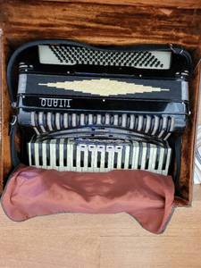 lot 127 image: Titano Accordion with Case and Traficante Accordion Band Series Sheet Music