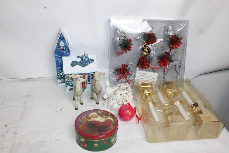 lot 2 image: Assorted Holiday Decorations Including Santa Tin, Reindeer Figurines, and Candle Holders