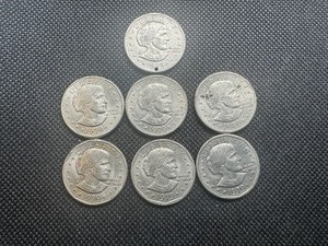 lot 97 image: 7 Susan B Anthony $1 coins 1 holed